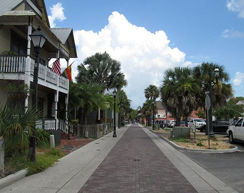 View of a sidewalk with trees and houses